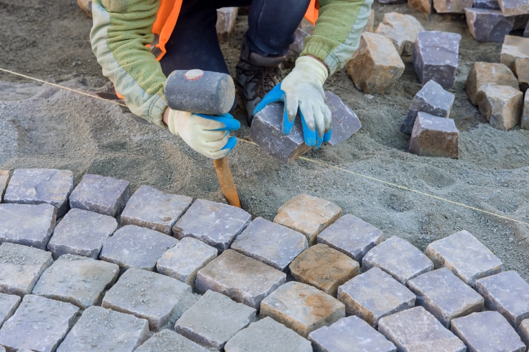 Pose de pavés en motif arrondi lors d’un aménagement extérieur à Martigues, illustrant la capacité de Solutions VRD à intervenir sur des chantiers résidentiels et industriels aux configurations variées.